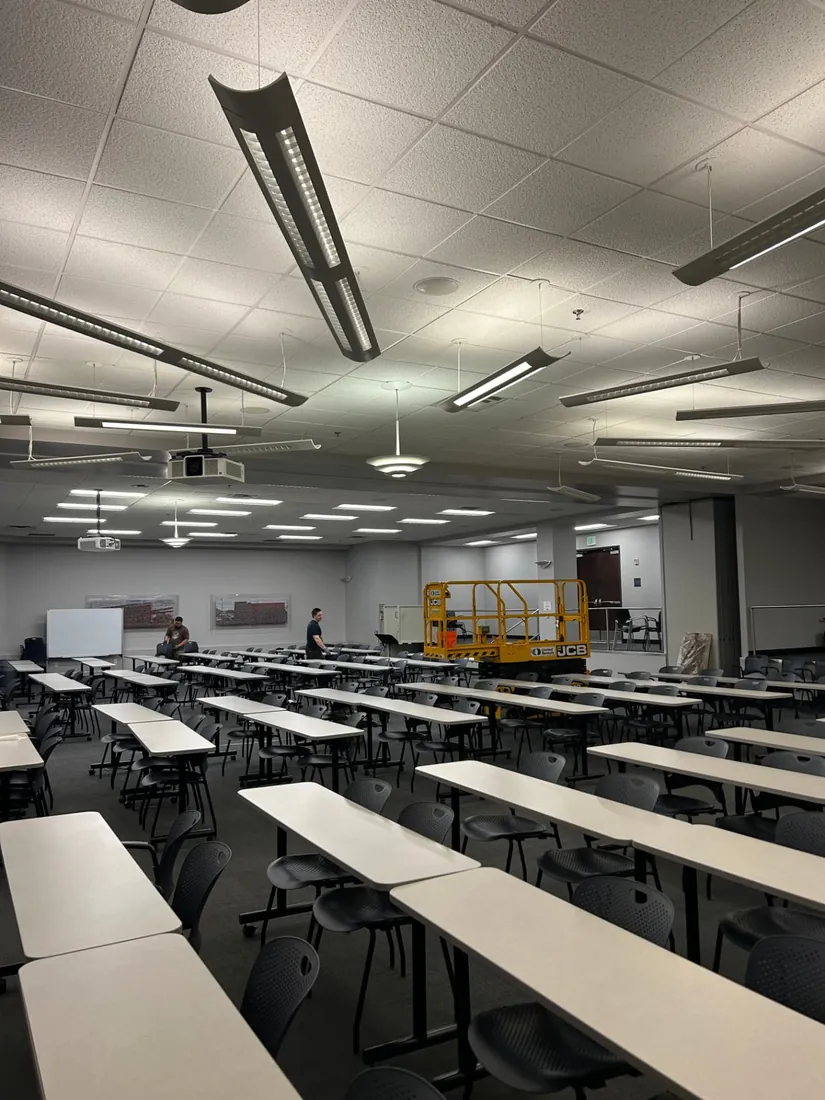 Suspended linear LED fixtures installed in a conference and training room
