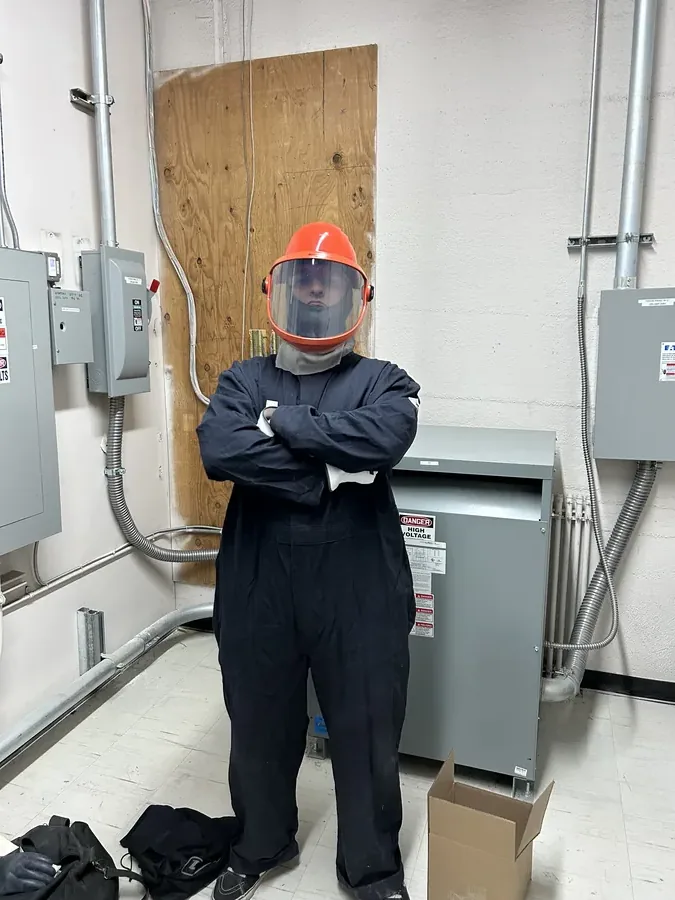 Arc-flash rated technician performing electrical diagnostics