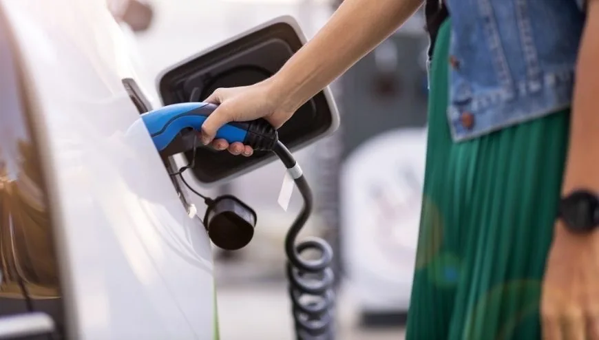 Homeowner plugging an electric vehicle into a newly installed Level 2 charger