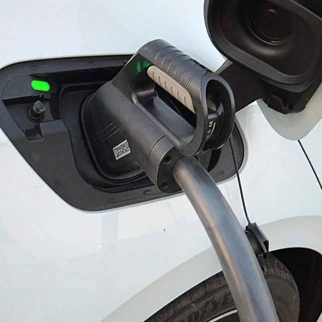 EV charging connector locked into a vehicle charge port on a completed home charger install