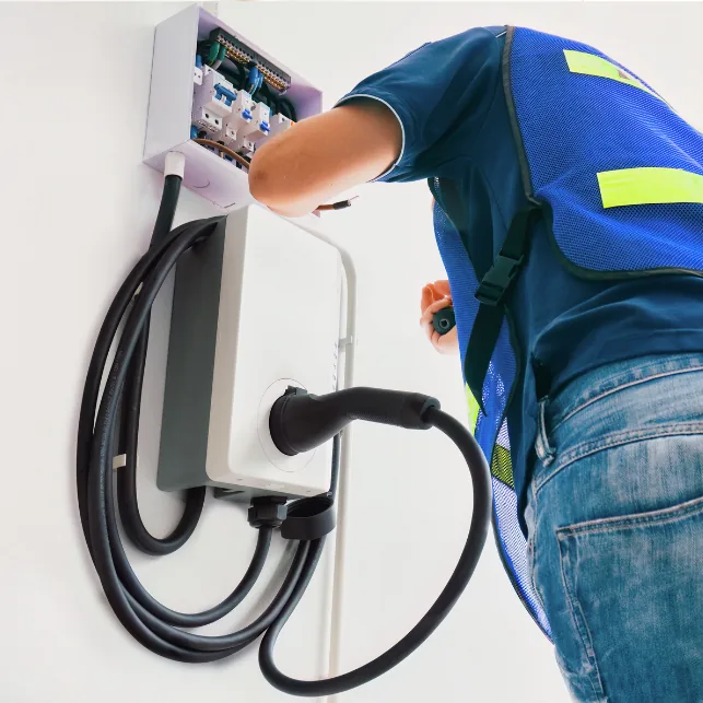Electrician hardwiring a Level 2 EV charger to a dedicated 240V circuit Electrician hardwiring a Level 2 EV charger to a dedicated 240V circuit