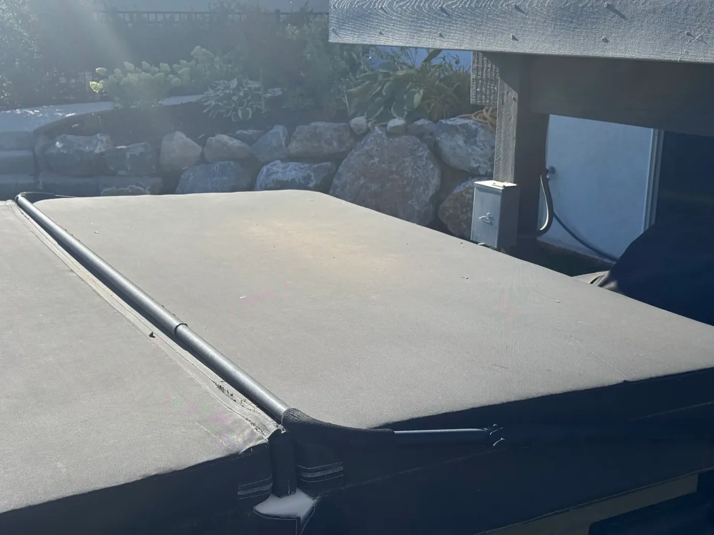 Hot tub cover and nearby weatherproof spa disconnect on a finished install