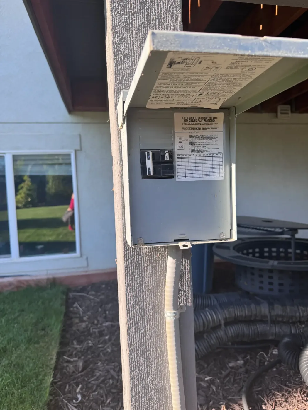 GFCI hot tub disconnect mounted on a post with the cover open showing the 60A spa breaker GFCI hot tub disconnect mounted on a post with the cover open showing the 60A spa breaker
