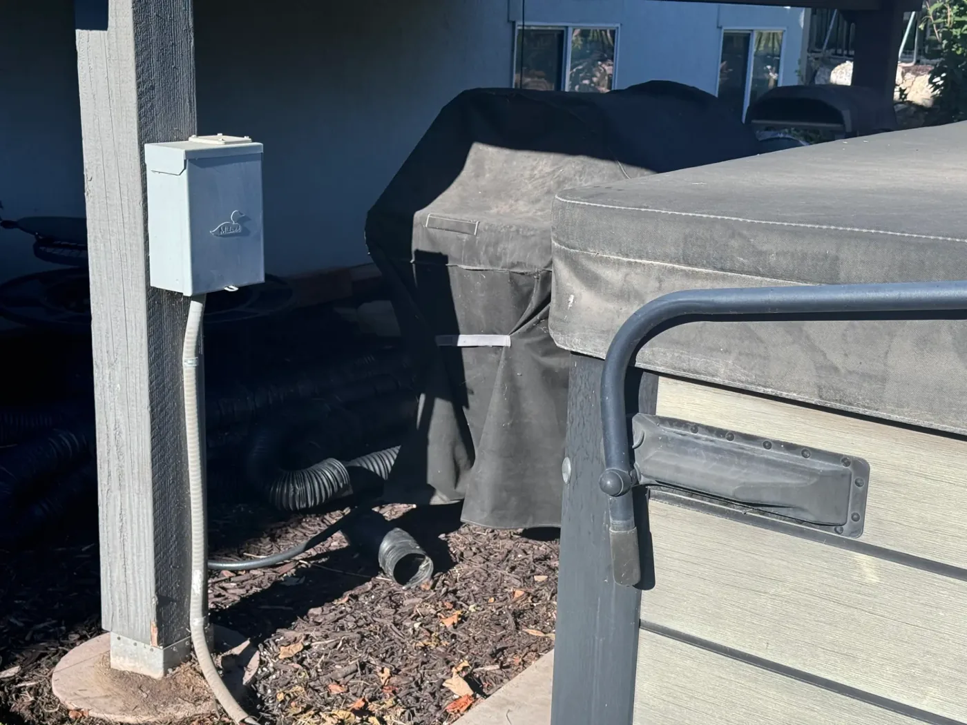 Hot tub disconnect installed within sight of the spa on a Salt Lake City patio