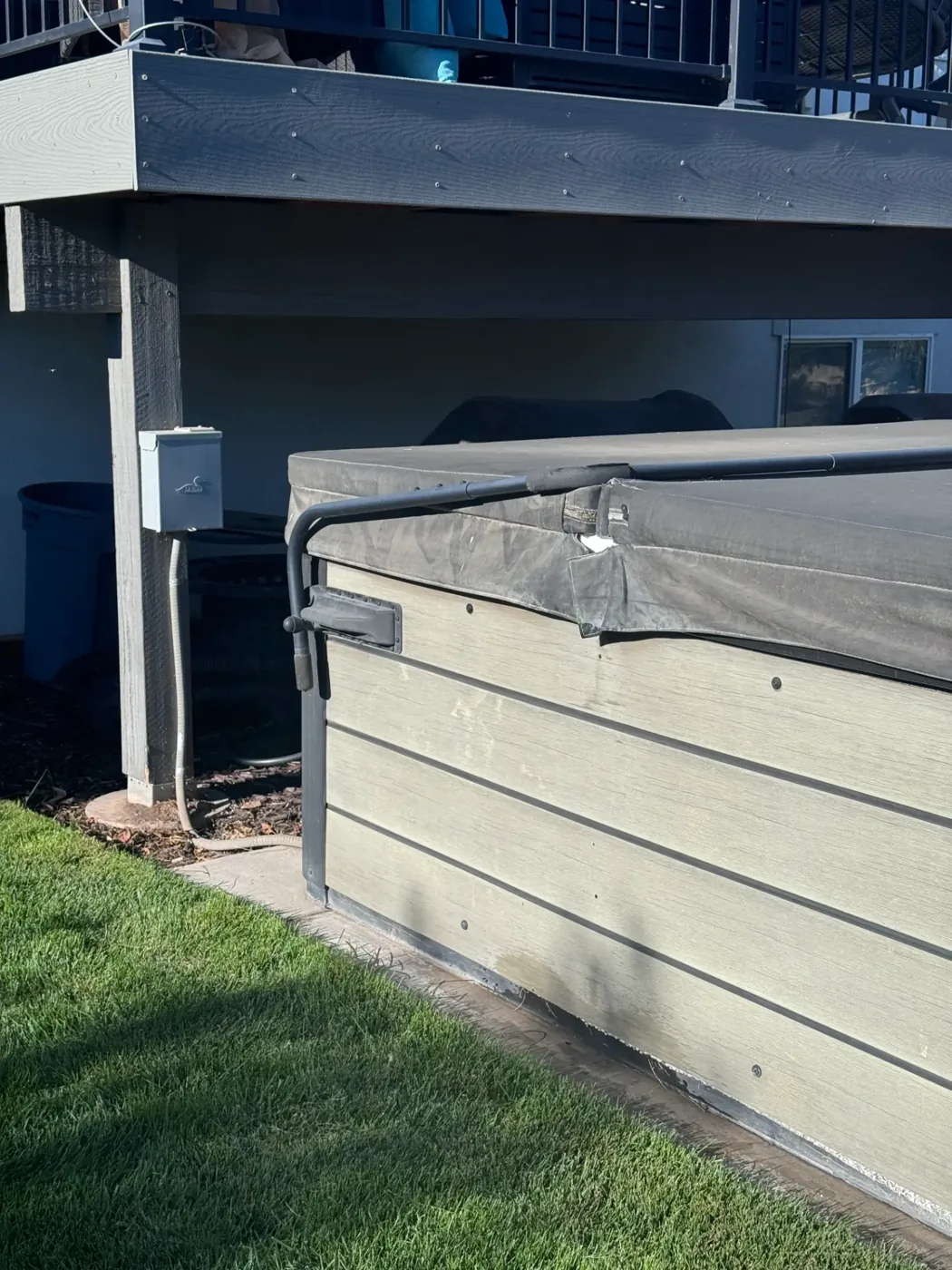 Spa circuit and disconnect wired under a deck next to an installed hot tub