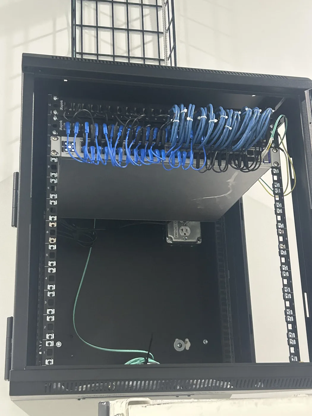 Wall-mounted network enclosure installed for a commercial tenant