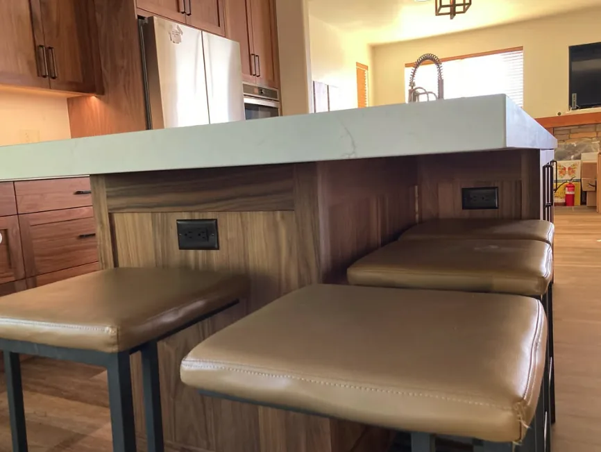 Remodeled kitchen island with new outlets and pendant lighting