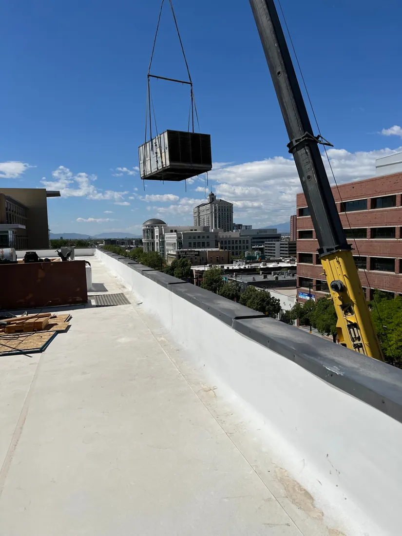Crane setting heavy equipment on a commercial rooftop in downtown Salt Lake City Crane setting heavy equipment on a commercial rooftop in downtown Salt Lake City