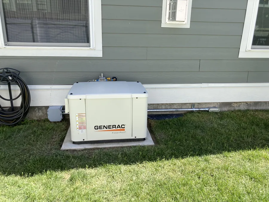 Whole-home standby generator installed on a concrete pad beside a Utah home Whole-home standby generator installed on a concrete pad beside a Utah home
